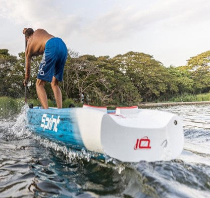 Starboard Sprint Carbon Sandwich race board from rear on the water with guy paddling